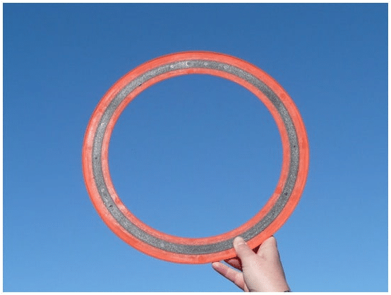 A person holding up a frisbee