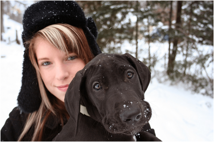 A girl with a dog in snowfall